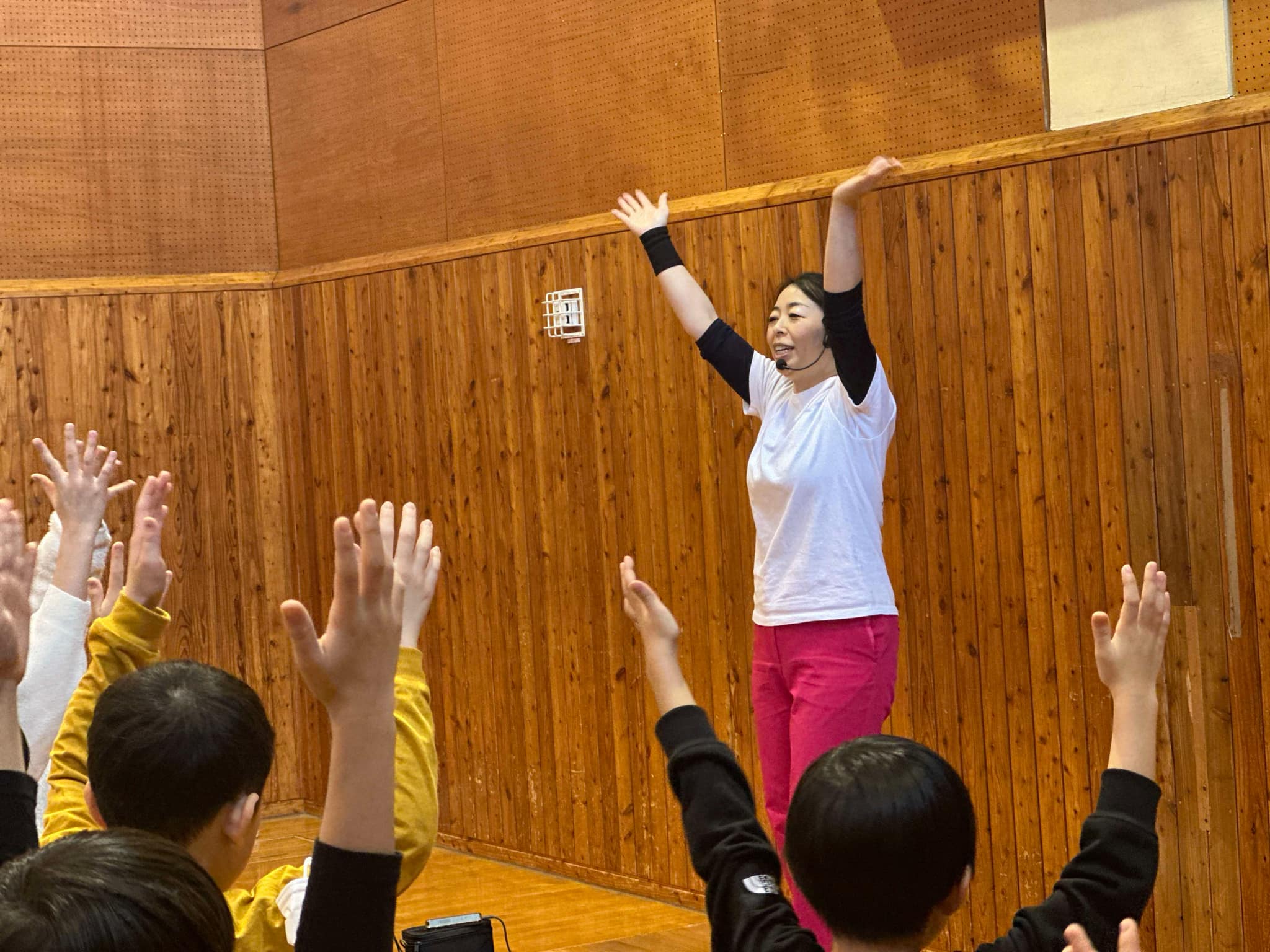 （写真①アイキャッチ兼用：パラパラを教える谷口さん）